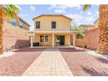 Well maintained backyard featuring pavers, a covered patio, and privacy wall at 11755 Garland Grove Ln, Las Vegas, NV 89183