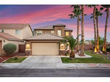Charming two-story home with a well-maintained front yard and a two-car garage under a beautiful pink and purple sky at 1200 Dream Bridge Dr, Las Vegas, NV 89144