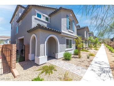 Charming two-story home features a welcoming arched entryway and low-maintenance desert landscaping at 1323 Cerulean Ave, Henderson, NV 89002