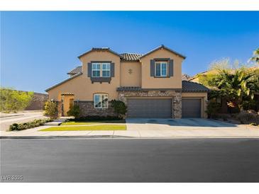 Charming two-story stucco home featuring a three-car garage and well-maintained landscaping at 29 Blue Valley Dr, Henderson, NV 89002