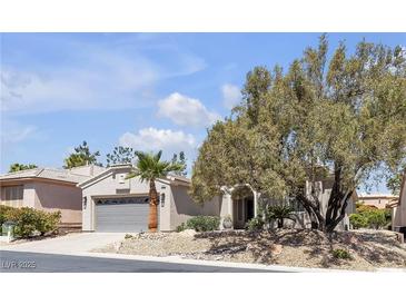 Charming single-story home with desert landscaping, mature tree, and two-car garage at 4227 Pacifico Ln, Las Vegas, NV 89135