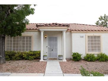 Charming single-story home with stucco siding and a tile roof. Covered entryway with decorative columns at 5400 Tassara Way # 106, Las Vegas, NV 89108