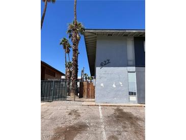 Modest apartment exterior with palm trees and limited parking area at 637 N 11Th St # 4, Las Vegas, NV 89101