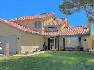 Charming two-story home with a well-maintained lawn and desert landscaping in a suburban neighborhood at 7400 Amigo St, Las Vegas, NV 89123