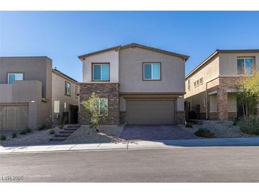 Beautiful two-story home with stone accents, a two-car garage, and a landscaped front yard at 9239 Albus Hills Ave, Las Vegas, NV 89143