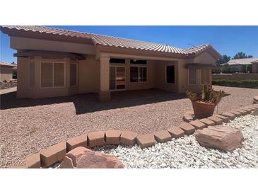 Inviting backyard featuring a covered patio, desert landscaping, and comfortable outdoor space at 2501 Maddington Dr, Las Vegas, NV 89134