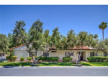 Charming single-story home featuring well-manicured landscaping and a classic tile roof at 2531 La Cara Ave, Las Vegas, NV 89121
