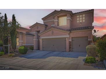 Charming two-story home featuring a two-car garage, landscaped front yard and a neutral color palette at 280 Goldstar St, Henderson, NV 89012