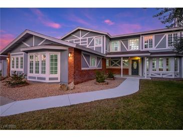 Charming two-story home featuring unique architectural detail and a well-manicured front lawn at 3531 W Arby Ave, Las Vegas, NV 89118