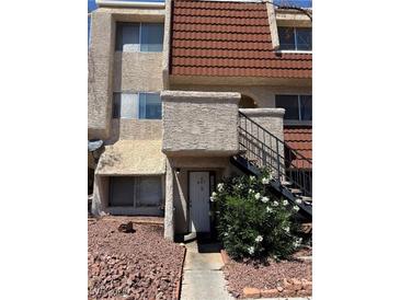 Two-story home with desert landscaping, red tile roof, and a private entrance via outdoor stairs at 3585 Arville St # 401A, Las Vegas, NV 89103