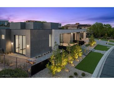 Modern home featuring a sleek design, minimalist landscaping, and a welcoming entrance at 38 Skybird Ct, Las Vegas, NV 89135