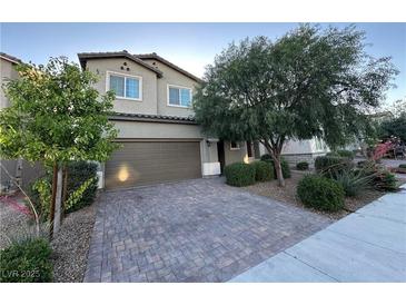 Charming two-story home featuring a well-maintained front yard and brick driveway, complemented by mature trees at 4633 Fragrant St, North Las Vegas, NV 89031