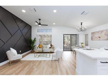 Bright living room featuring a modern decor, luxury furniture, and dark accent wall at 502 Edgefield Ridge Pl, Henderson, NV 89012