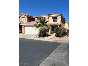 Two-story home featuring a desert landscape with a palm tree and a two-car garage at 5456 Raccoon Valley Ln, Las Vegas, NV 89122