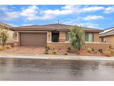 Beautiful single-story home featuring a low-maintenance landscaped front yard and a two-car garage at 741 Monroe Hill Pl, Henderson, NV 89011