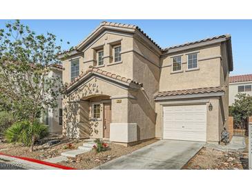 Charming two-story home featuring a tile roof, stucco siding, and a well-manicured front yard, plus an attached garage at 765 Jewel Tower St, Las Vegas, NV 89178