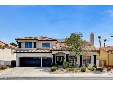 Charming two-story home with a three car garage and nicely landscaped front yard at 8713 Castle Ridge Ave, Las Vegas, NV 89129