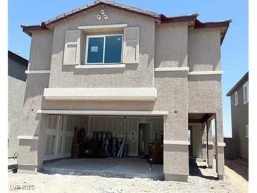 Two-story tan home featuring an attached two-car garage and unfinished landscaping at 10400 Luna Mezzo St Ave # Lot 193, Las Vegas, NV 89141