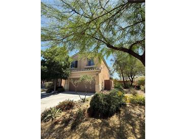 Charming two-story home with landscaped yard and two car garage, shaded by mature trees in a well maintained neighborhood at 10692 Tulip Valley Rd, Las Vegas, NV 89179