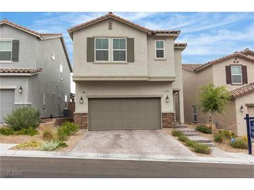 Inviting two-story home with a two-car garage and charming desert landscaping, enhancing curb appeal at 10836 Montana Blanca Ave, Las Vegas, NV 89166