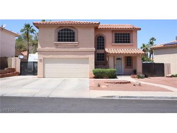 Charming two-story stucco home featuring a two-car garage, red tile roof, and drought-tolerant landscaping at 1482 Flintrock Rd, Henderson, NV 89014