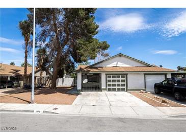 Charming single-story home with a two-car garage, palm tree, and well-maintained front yard at 1878 Corvette St, Las Vegas, NV 89142