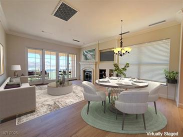 Bright living room with fireplace, dining area, and access to outdoor balcony with lake views at 21 Via Visione # 206, Henderson, NV 89011