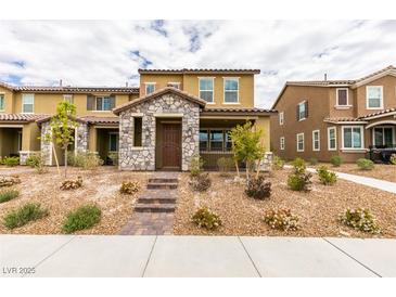 Charming two-story home with stone accents and desert landscaping, steps up to the front door at 3270 Palindrome Ave, Henderson, NV 89044