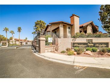 Welcoming entrance to Flamingo Heights featuring desert landscaping and a gated entry at 4083 Nook Way # D, Las Vegas, NV 89103