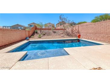 Private in-ground pool in backyard with a view of the desert landscaping at 5079 Quiet Falls Ct, Las Vegas, NV 89141