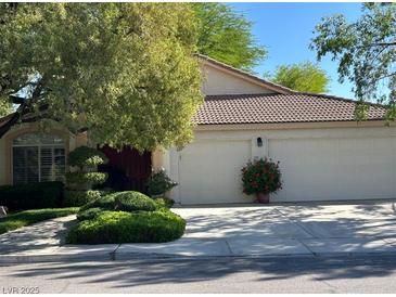 Charming home with a two-car garage, mature landscaping, and a meticulously maintained front yard at 1782 Castro Hill Ave, Henderson, NV 89012
