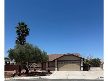 Charming single-story home with mature trees and a well-maintained front yard and a two car garage at 1816 Mazzanti Way, Henderson, NV 89014