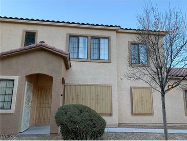 Charming townhome features stucco exterior, tiled roof, and desert landscaping at 2121 Hussium Hills St # 107, Las Vegas, NV 89108