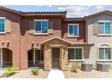 Charming two-story townhouse featuring a stone-accented entrance and a well-maintained, xeriscaped front yard at 25 Barbara Ln # 36, Las Vegas, NV 89183