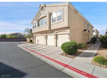 Attractive townhome with three-car garage and well-kept landscaping and ample parking at 4675 Color Up Ct # 101, Las Vegas, NV 89122