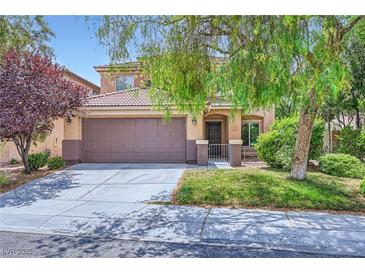 Charming two-story home featuring a well-manicured lawn, covered entrance, and a two-car garage at 529 Caribbean Palm Dr, Las Vegas, NV 89138