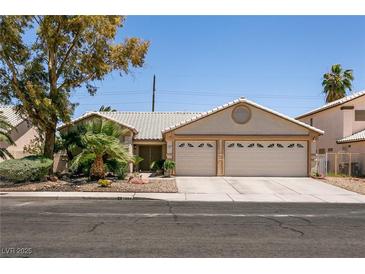 Charming single-story home featuring a two-car garage and well-maintained landscaping at 5824 Kane Holly St, Las Vegas, NV 89130