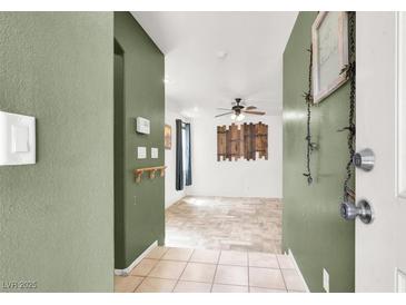 Inviting entryway featuring neutral paint, tile flooring, and an open floor plan leading into the spacious living area at 6581 Netherseal Ave, Las Vegas, NV 89139
