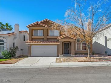 Charming two-story home featuring a classic design with a red tile roof and an attached two-car garage at 8733 Country Pines Ave, Las Vegas, NV 89129
