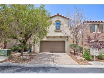 Charming two-story home featuring an attached two-car garage and mature landscaping at 11221 Victoria Medici St, Las Vegas, NV 89141