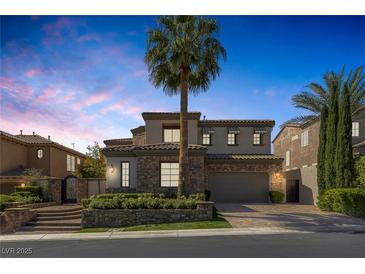 Beautiful two-story home with stone accents, a tile roof, and lush landscaping at 11503 Glowing Sunset Ln, Las Vegas, NV 89135