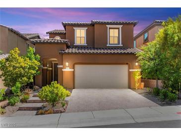 Charming two-story home features a paver driveway and a well-maintained, landscaped front yard at 11847 Corenzio Ave, Las Vegas, NV 89138