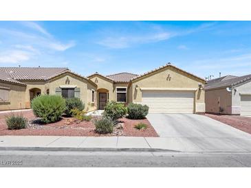 Charming single-story home with a well-maintained front yard and attached two-car garage at 1212 E Rome Blvd, North Las Vegas, NV 89086