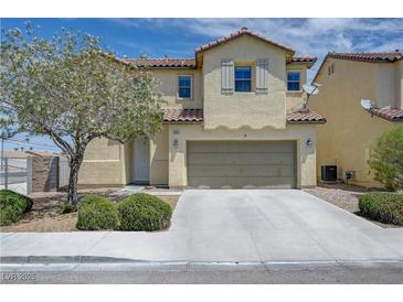 Charming two-story home with a neutral color scheme, desert landscaping, and an attached two-car garage at 1952 W Hammer Ln, North Las Vegas, NV 89031