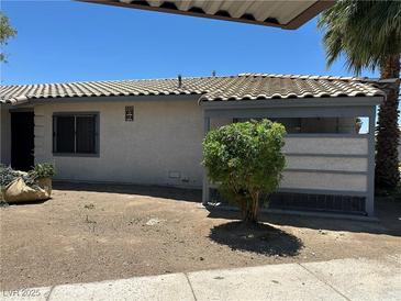 Modest single-story home with a stucco exterior, tiled roof, and desert landscaping at 227 N Lamb Blvd # A, Las Vegas, NV 89110