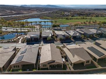 An aerial view showing homes in a community with a nearby golf course and water features at 44 Alta Cascata Pl, Henderson, NV 89011