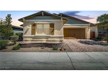 Charming single-story home with a well-maintained front yard and a two-car garage with brick paver driveway at 480 Heritage Bridge Ave, Henderson, NV 89011