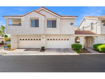Charming townhome featuring white stucco, red tile roof, and spacious two-car garages at 5201 S Torrey Pines Dr # 1221, Las Vegas, NV 89118