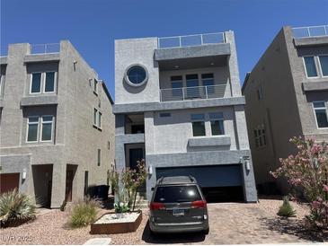 Contemporary two-story home featuring a balcony, rooftop terrace, and a convenient attached two-car garage at 8076 Haywood Estate Ave, Las Vegas, NV 89113