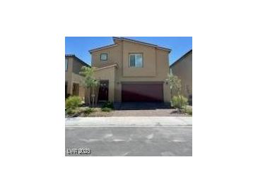 Inviting two-story home boasting a modern design with a two-car garage and easy-care landscaping at 1885 Vass Springs Pl, North Las Vegas, NV 89084